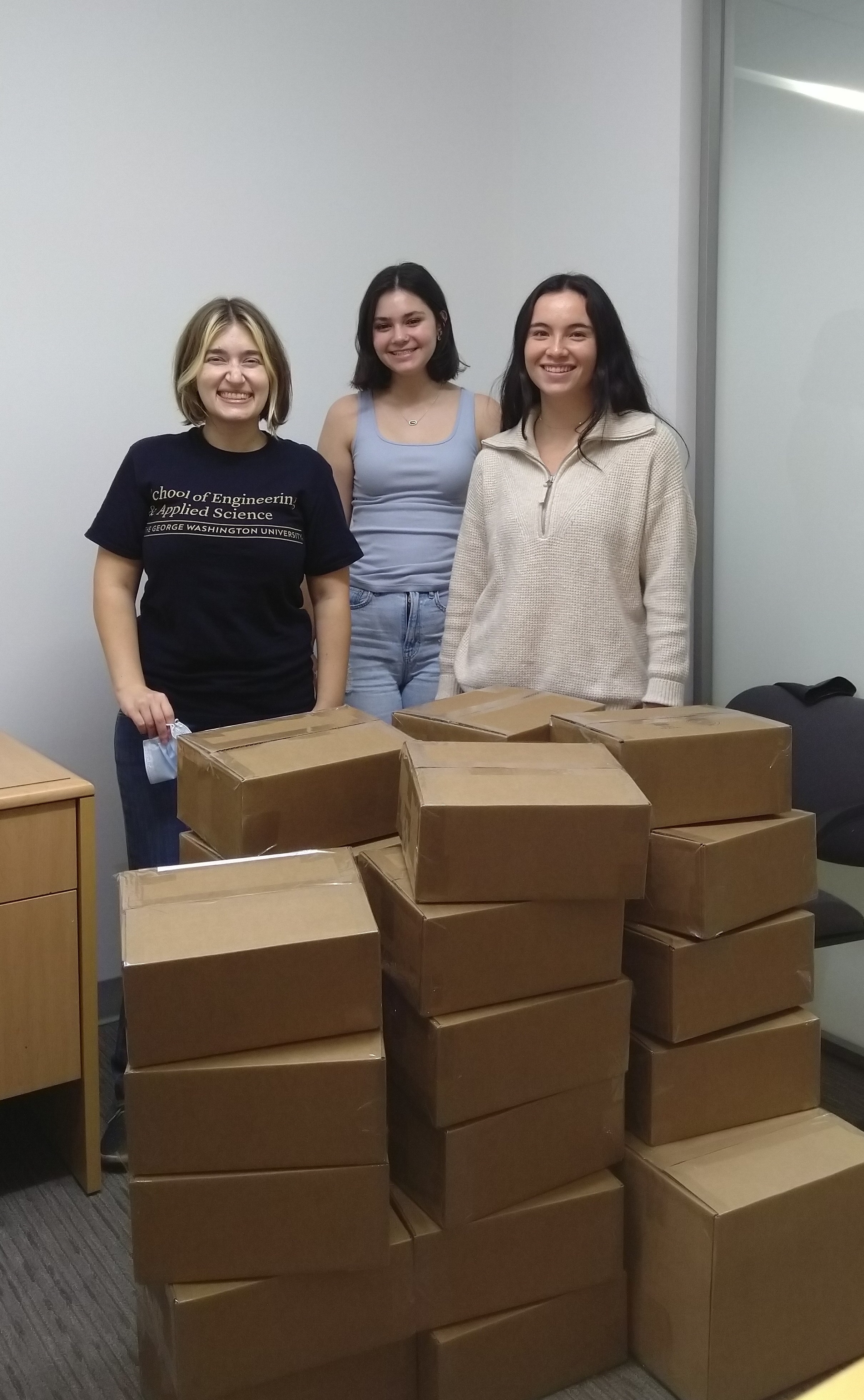 Elyse Nicolas, Lauren Schmidt, and Catherine Meadows with post-camp boxes of supplies