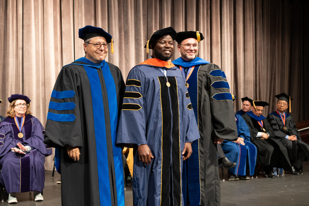 Professor Shahram Sarkani and Dean Lach pictured with Bernard Asare at the Spring 2024 Doctoral Hooding Ceremony. Asare received a doctorate in Cybersecurity Analytics from GW Engineering Online.