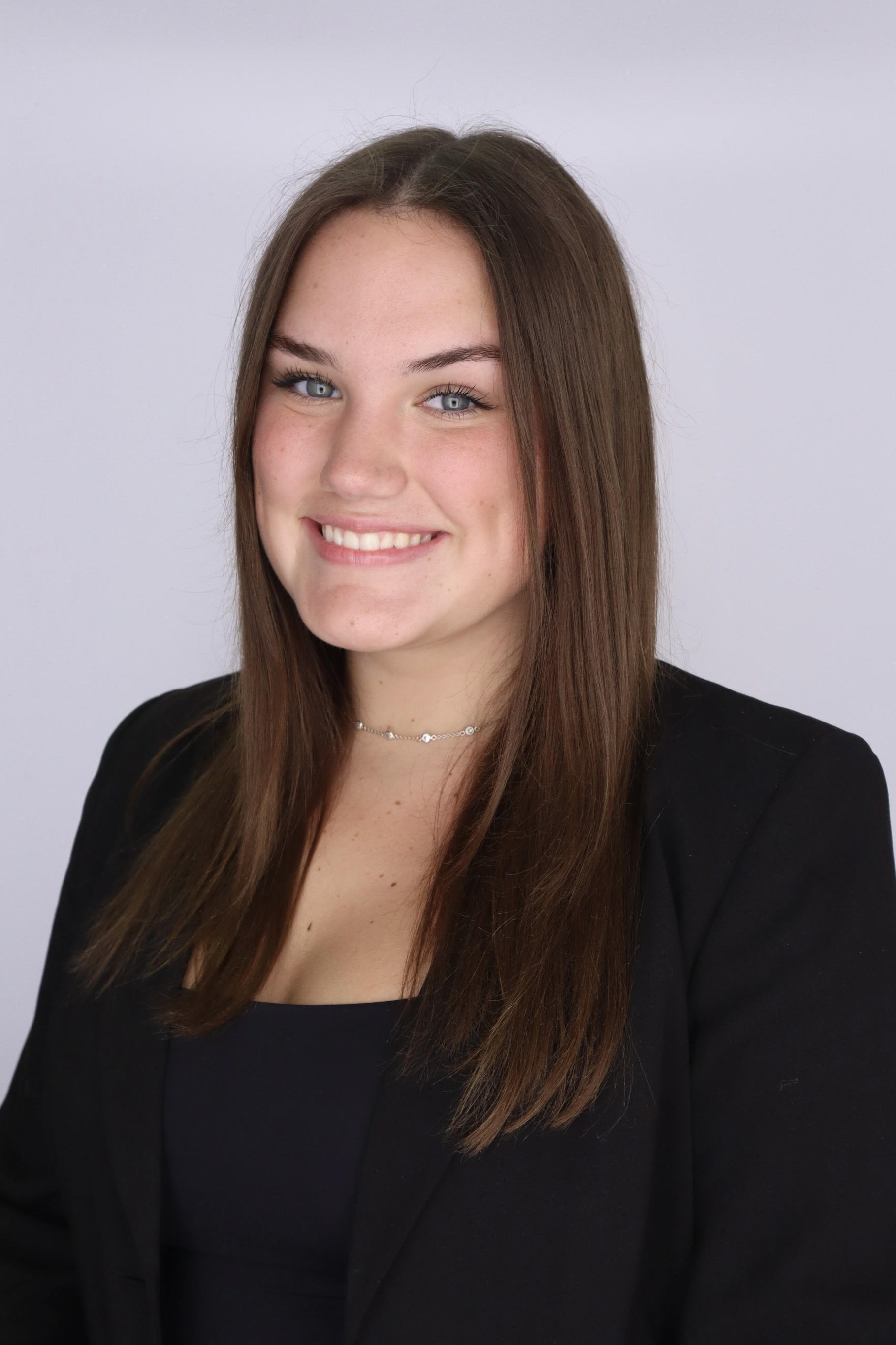 headshot of Grace in a black jacket and shirt