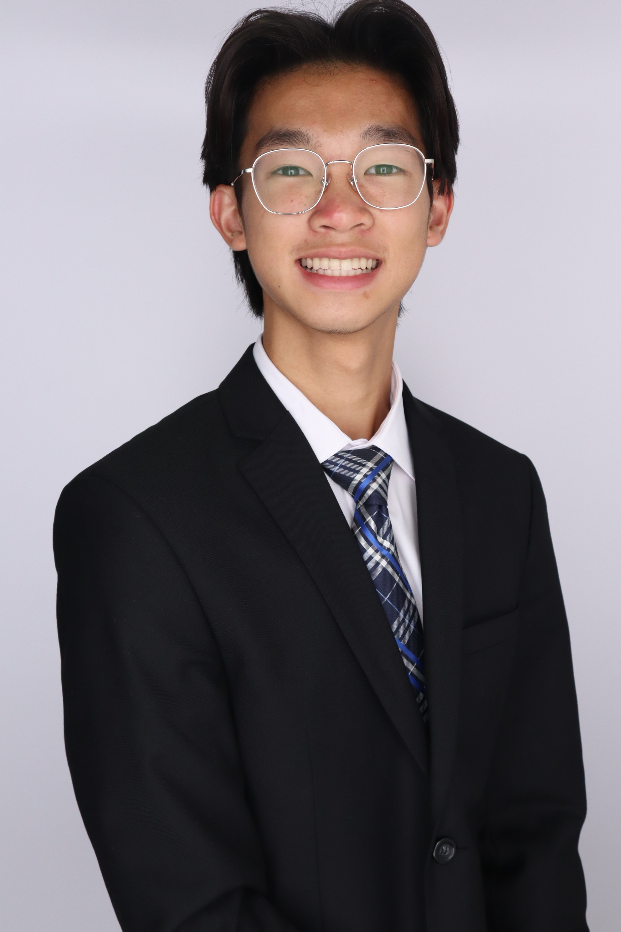 Patrick in a black suite and tie