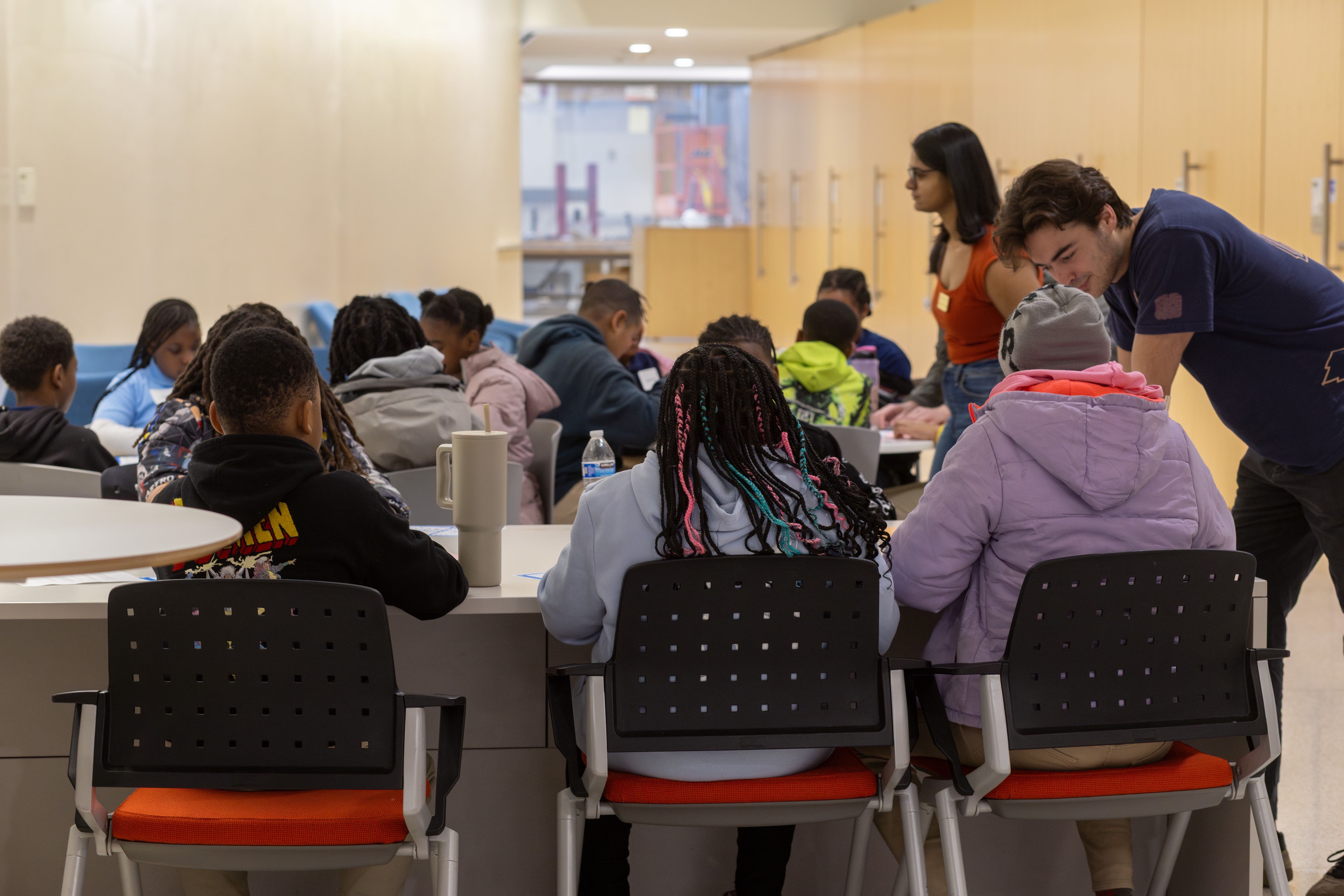 GW Engineering volunteers talk with elementary students