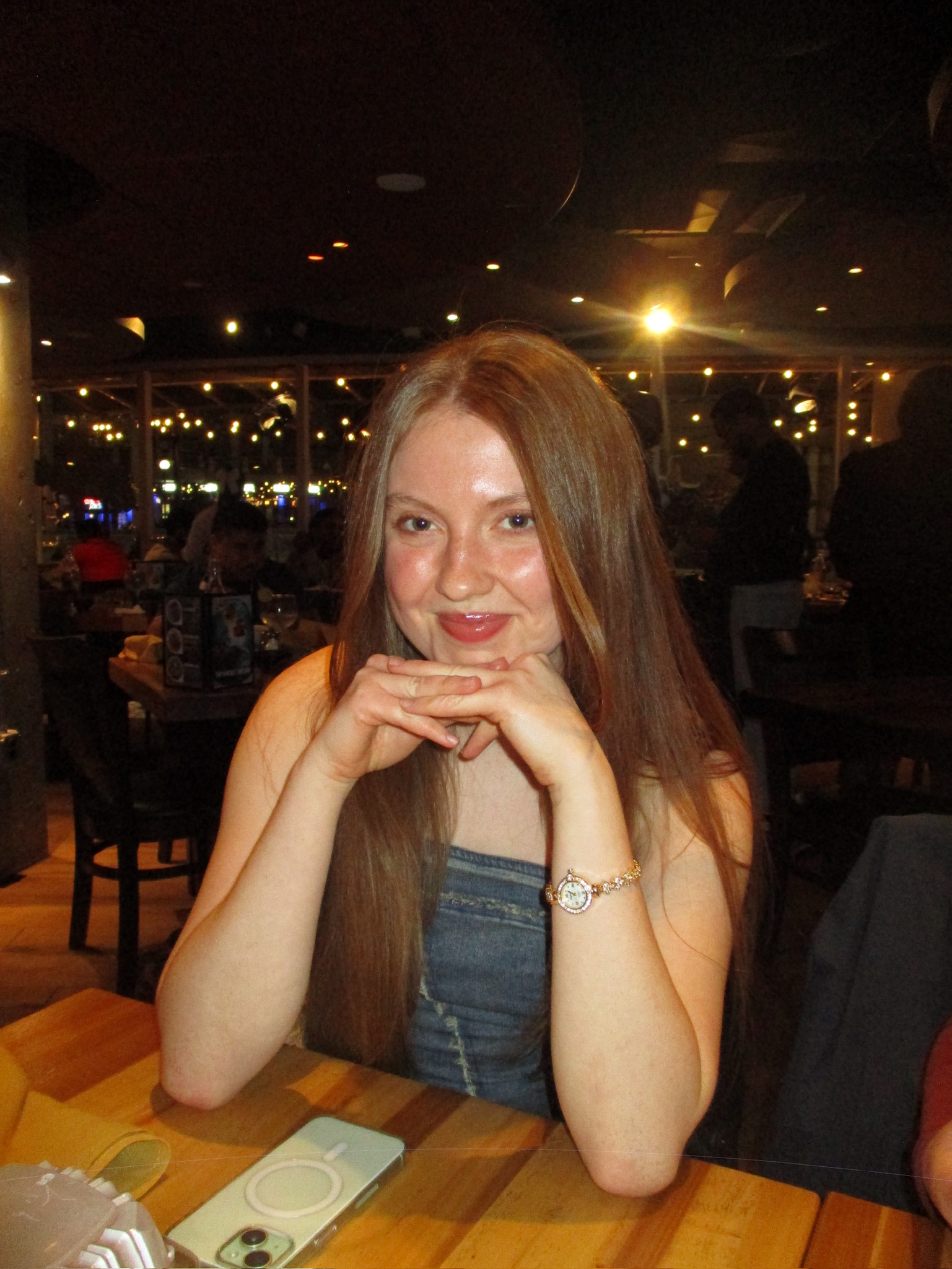 Grace N sitting at a dinner table