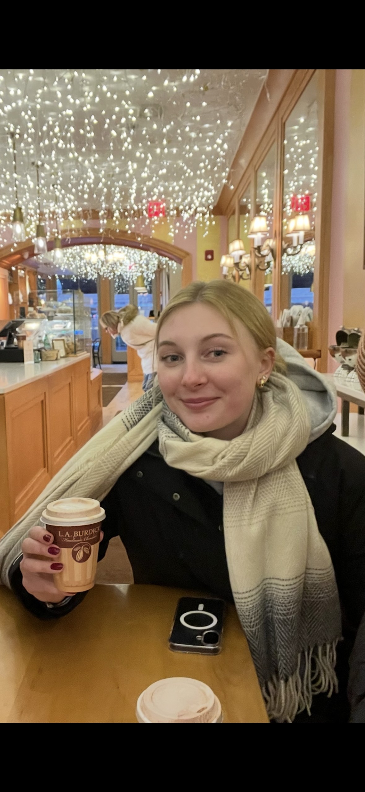 Jillian drinking a cup of coffee