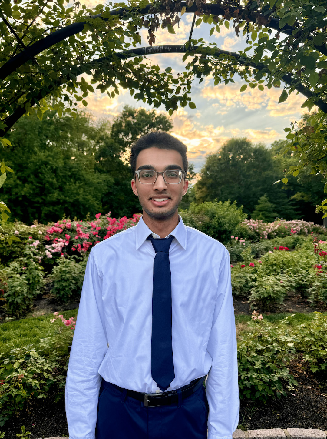 Kamran standing in a garden