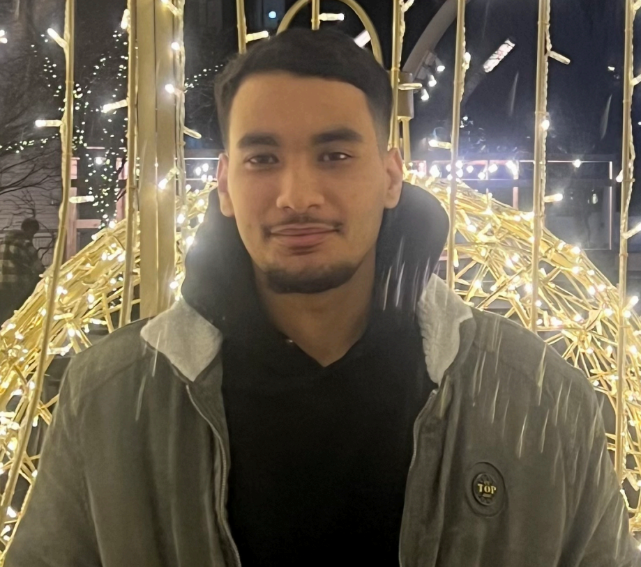 Mostafa in a olive jacket and black hoodie