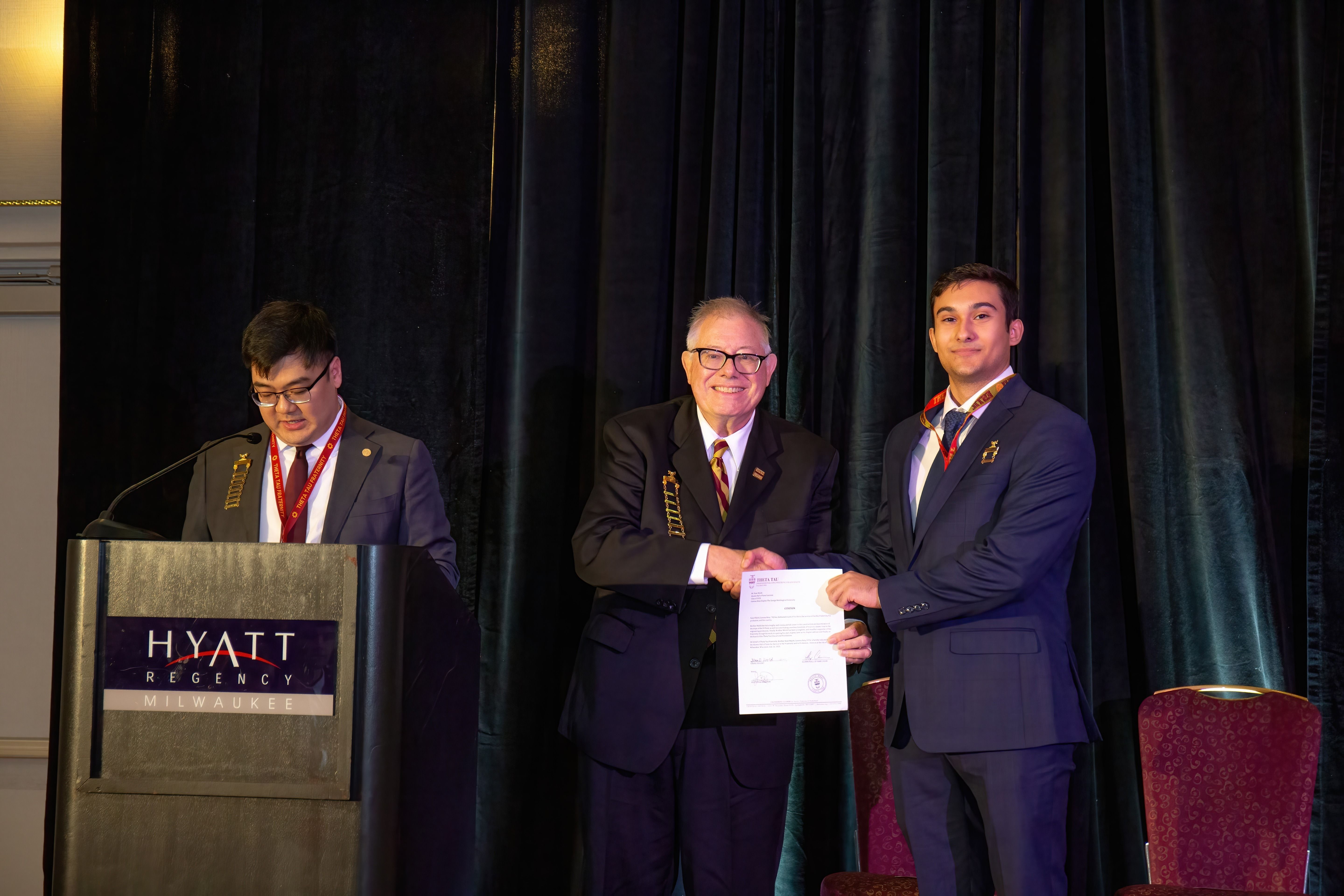 Sean Walsh being presented his award by Nicolas Perennino