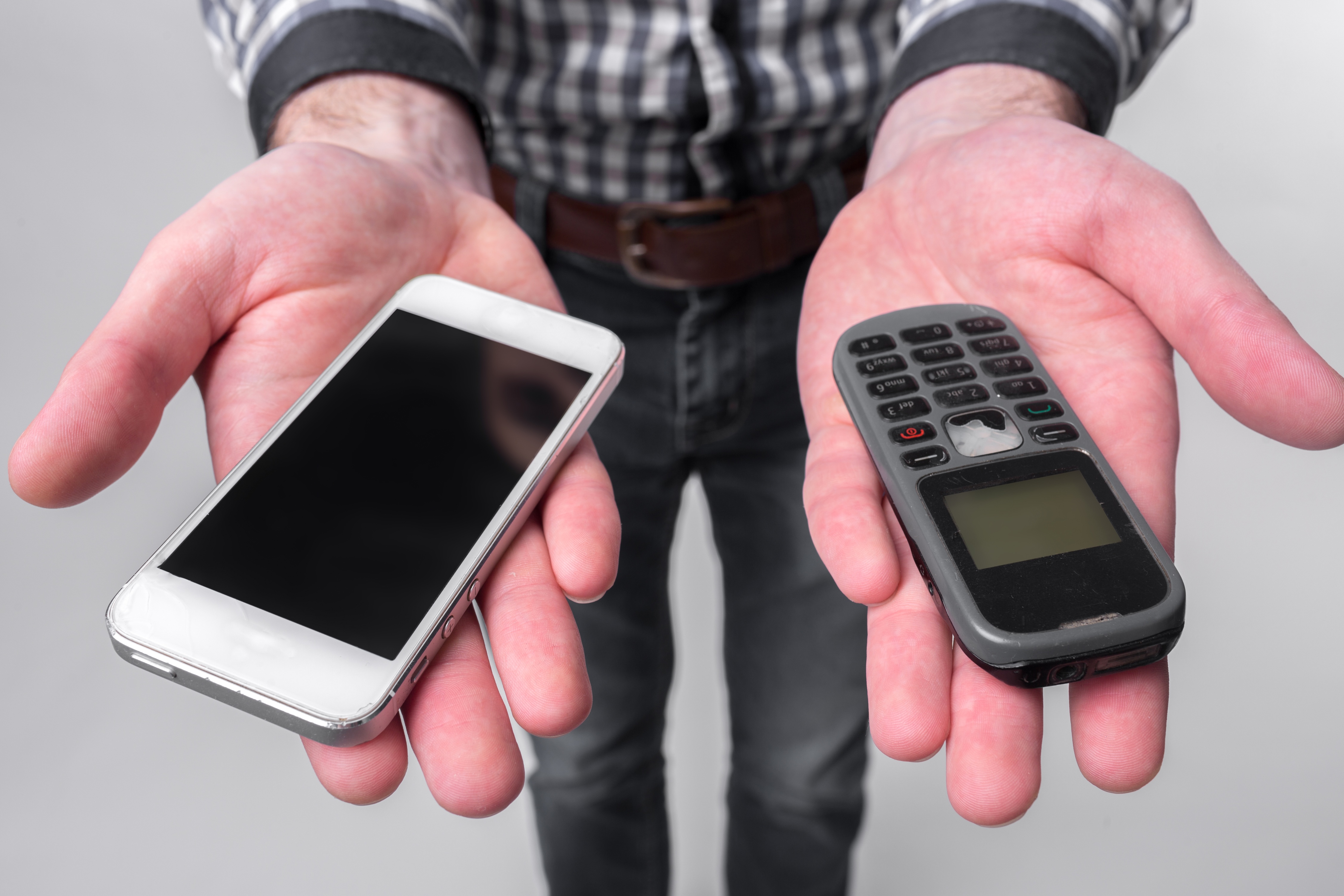 Stock image of person holding a phone in each hand