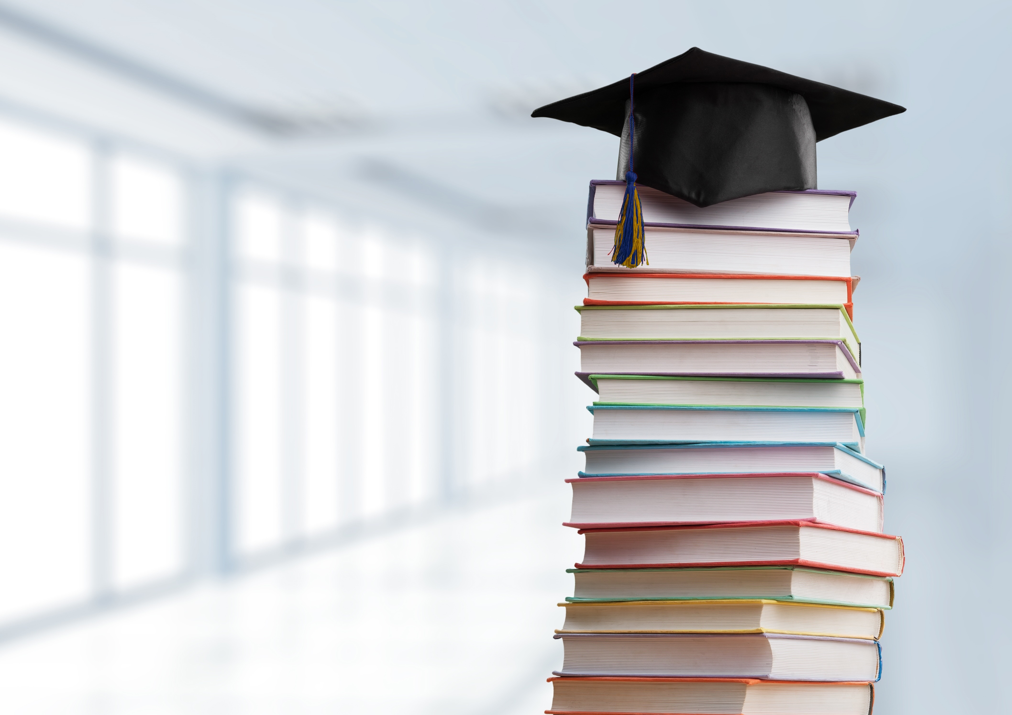 Books with a grad cap ontop