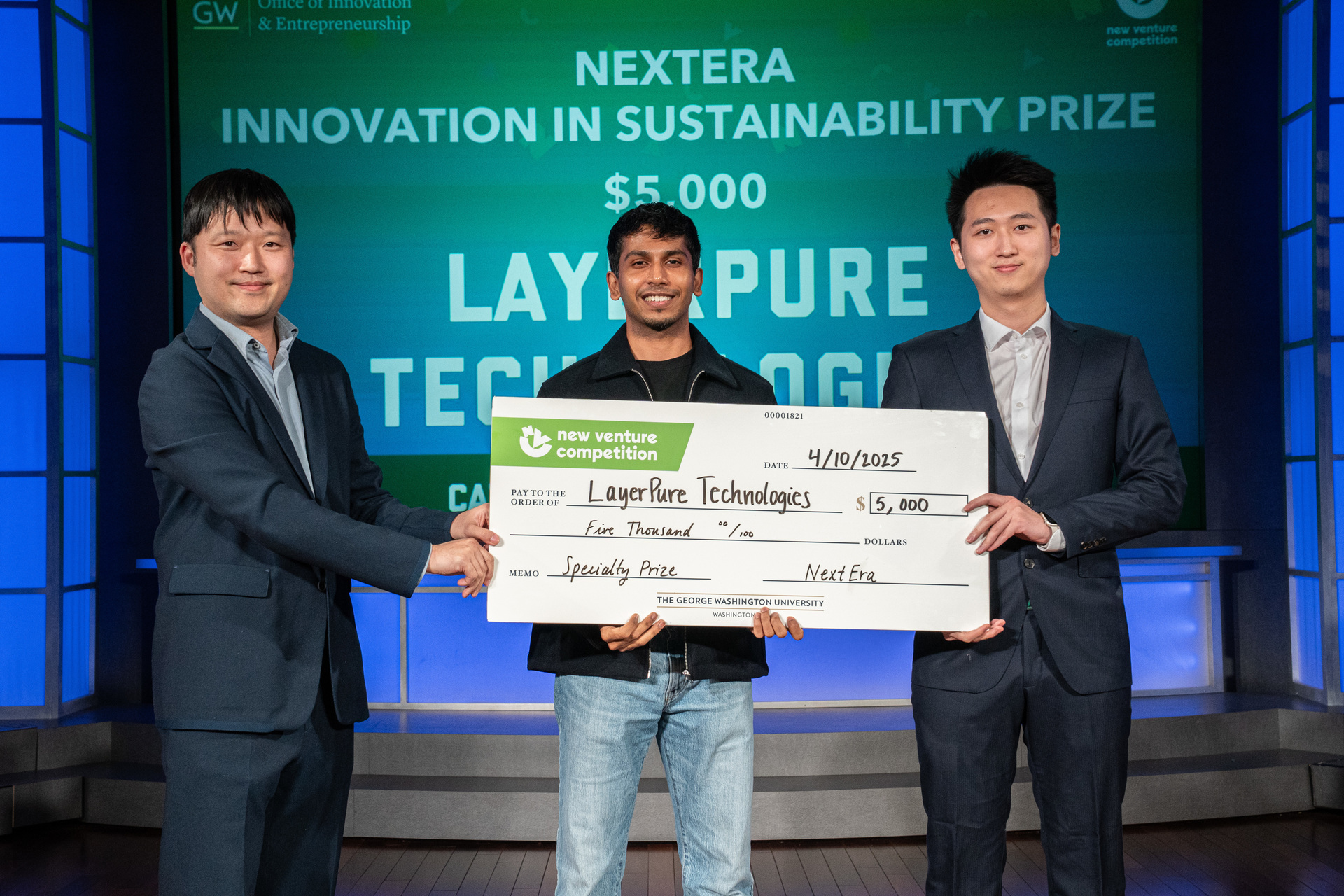 The students pictured with award check at the New Venture Competition