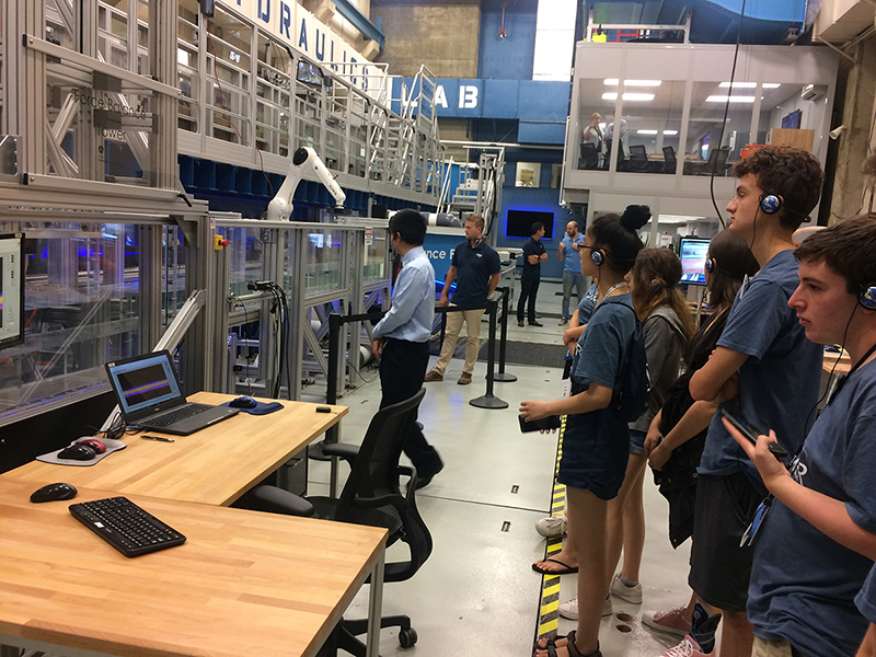 students standing in front of force balance tower