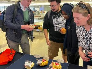Students choosing their popcorn at the Women's History Celebration Booth