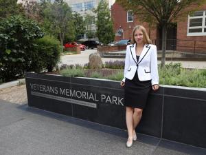 Sarah Malinowski standing in front of Veterans Memorial Park sign