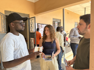 Elmore and Hatcher talking with a member of the Yumbe community about the existing library