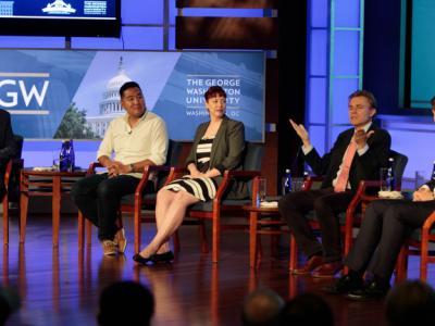 From left: Steven Livingston, Adam Conner, Rebekah Tromble, Neil Johnson and Jack Nassetta sitting on a stage