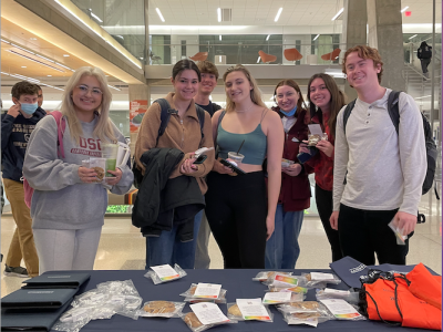 Students picking up their cookies at the Black History Celebration Booth on February 14