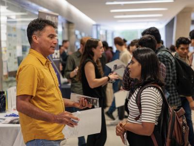 A student conversing with a potential employer in the Science & Engineering Hall