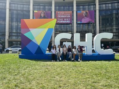 Computer Science undergraduate students posing in front of the GHC sign