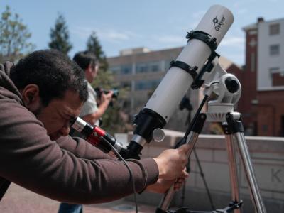 Student looking through a telescope