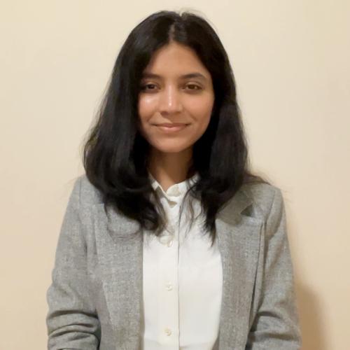 Student in a grey blazer and white collard shirt