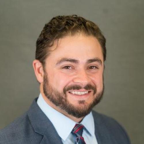 Male headshot in a grey suit