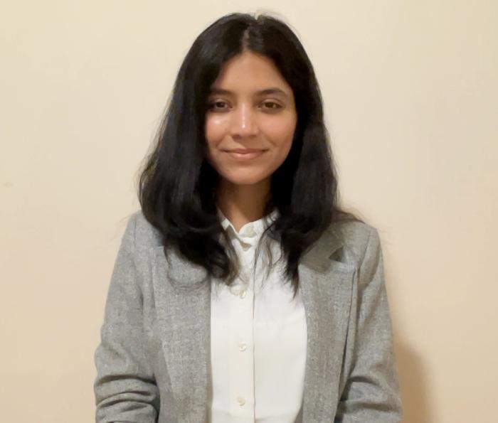 Student in a grey blazer and white collard shirt