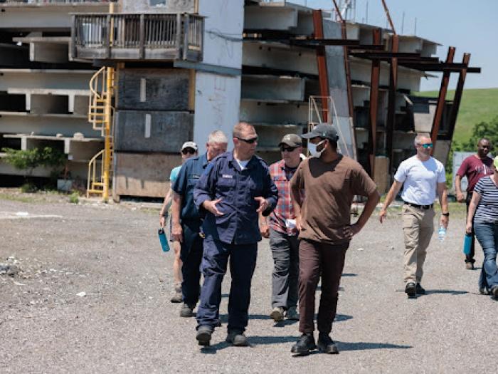 Group of people walking away from fire and rescue testing building
