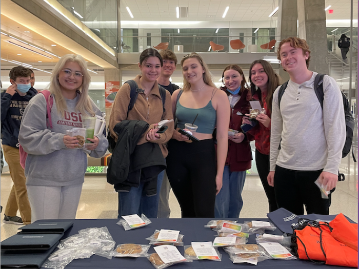 Students picking up their cookies at the Black History Celebration Booth on February 14