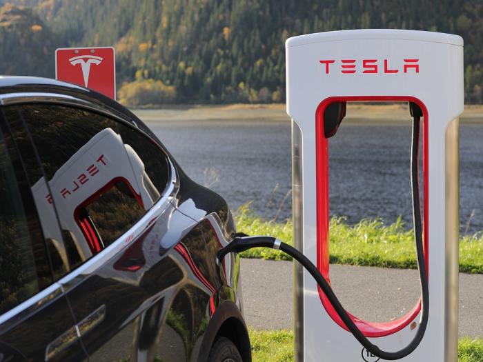 Tesla charging at a station