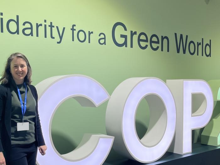 Professor Grady stands in front of a #COP29 sign at COP29 in Baku, Azerbaijan.