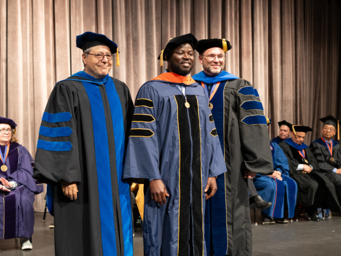 Professor Shahram Sarkani and Dean Lach pictured with Bernard Asare at the Spring 2024 Doctoral Hooding Ceremony. Asare received a doctorate in Cybersecurity Analytics from GW Engineering Online.