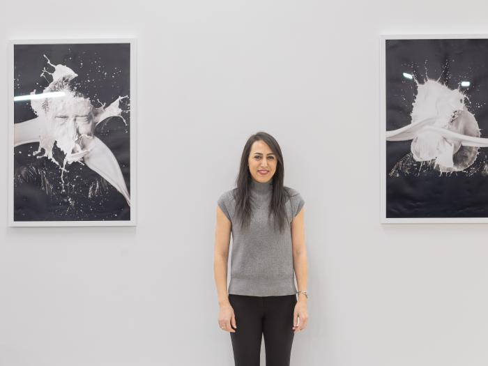 Panah pictured with images from the piece, “The Splash of Milk Streams Impacting a Solid Surface”
