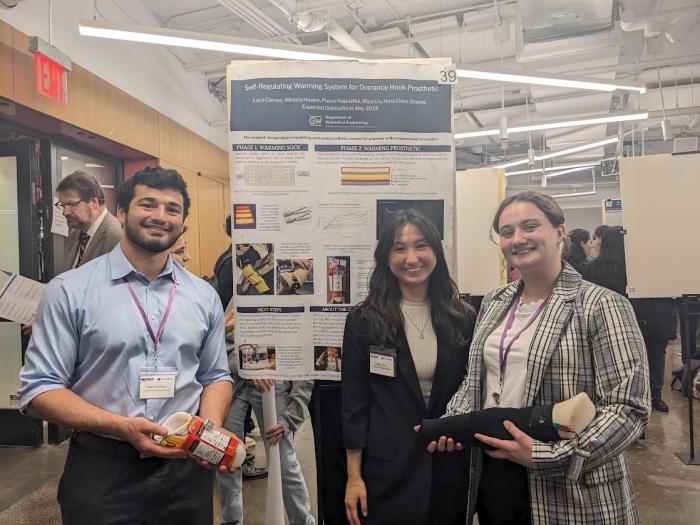 Students from the award-winning team standing in front of their research poster.