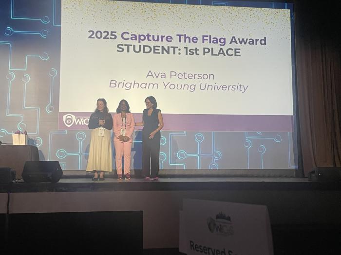 Ilakkiya Vijayakumar (middle) pictured on stage with the first place winner.